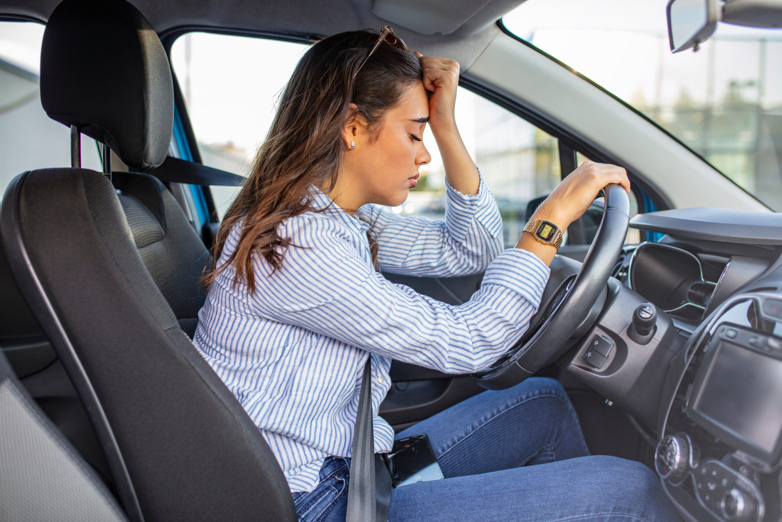 Frustrated woman in an immobilized car due to a failed OTA update